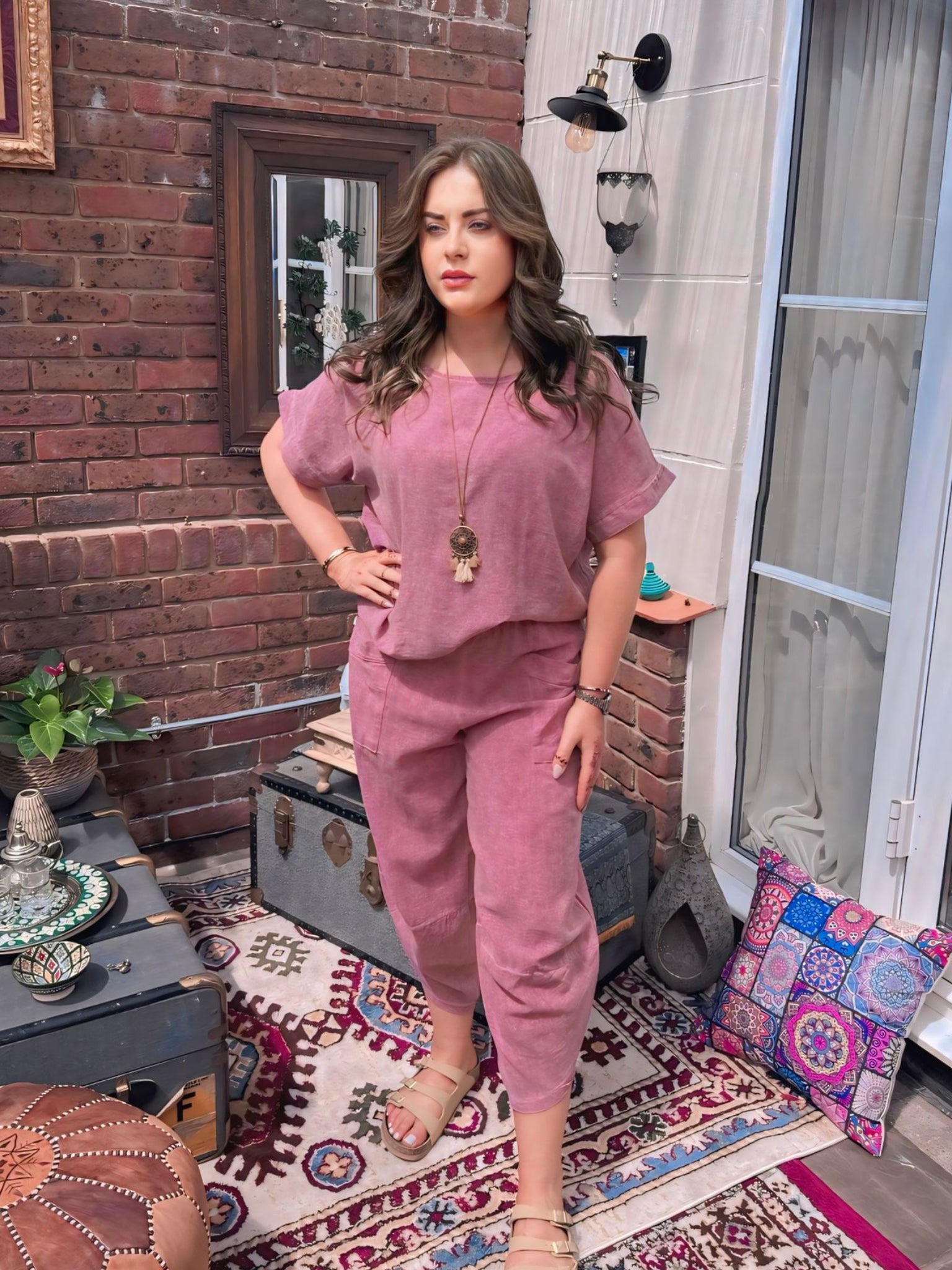 Woman in a dusky pink co-ord -outfit cotton top and cotton harem pants.